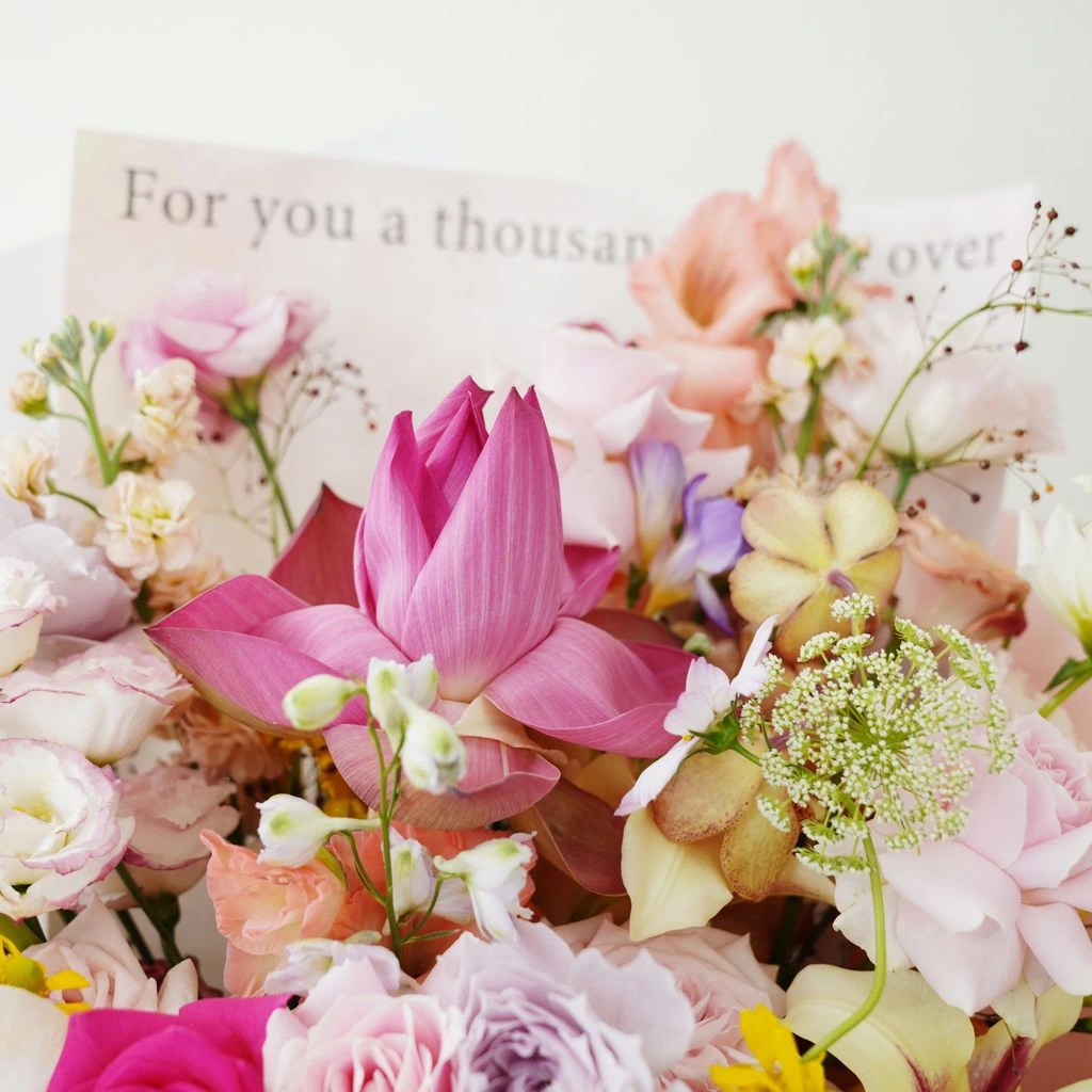 A soft lavender thinking-of-you bouquet in kraft paper
