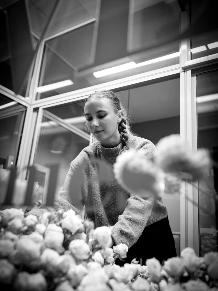 Local artisan florist hand-arranging a same-day bouquet in her shop